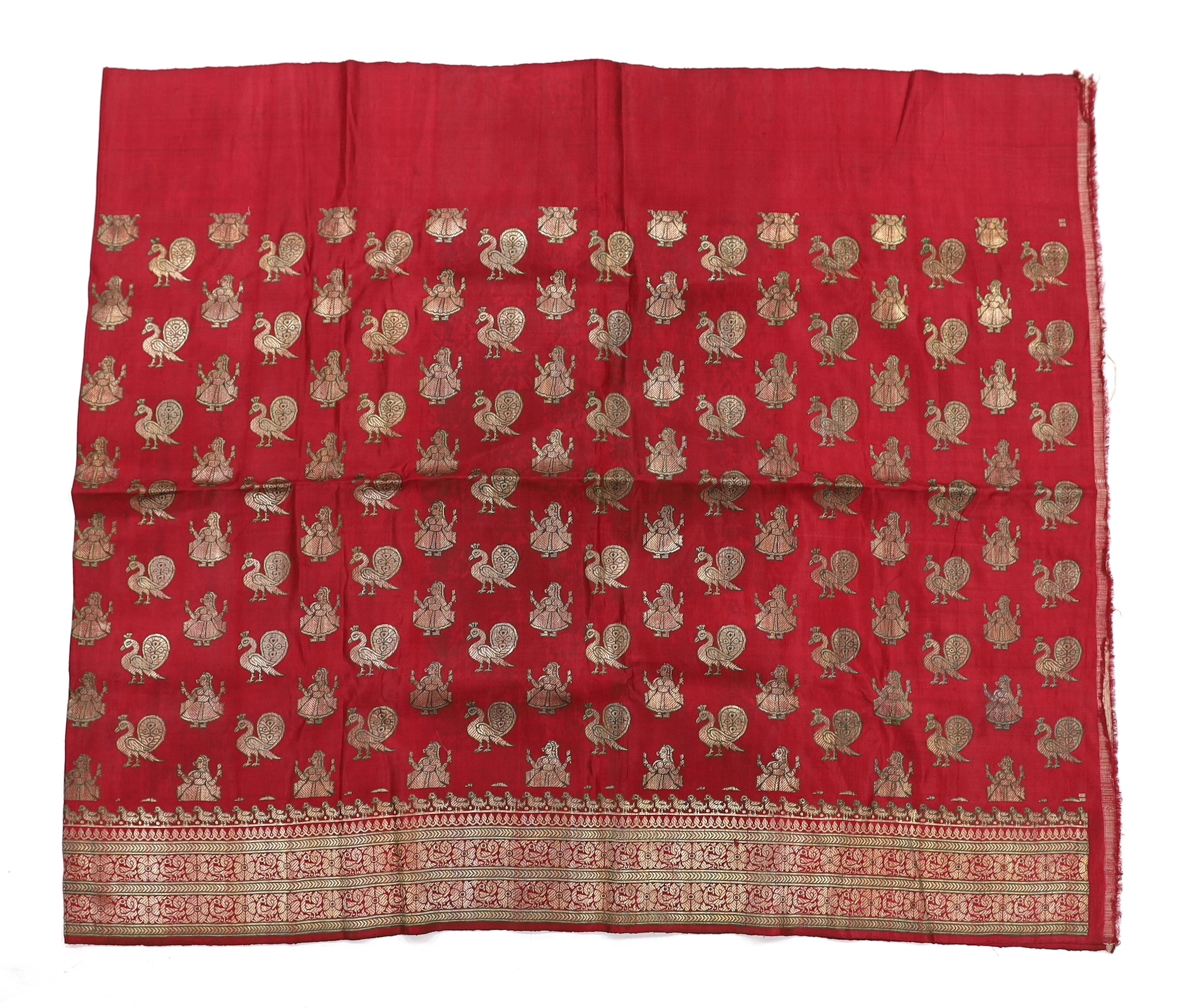 A 19th century fine cream woven Kashmiri shawl with blue and red teardrop design borders, an early 20th century gold satin pelmet with spot motifs of peacocks and flowers, 204cm long x 71cm high and a length of silk with